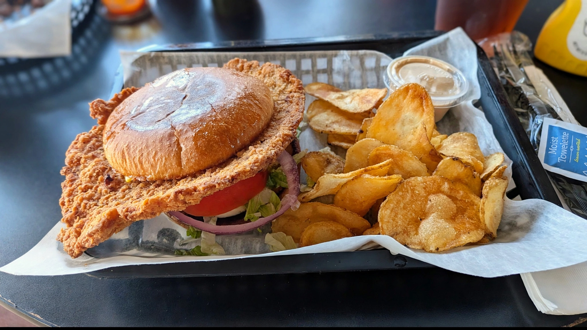 Crispy chicken sandwich with chips at Wings Sports Bar